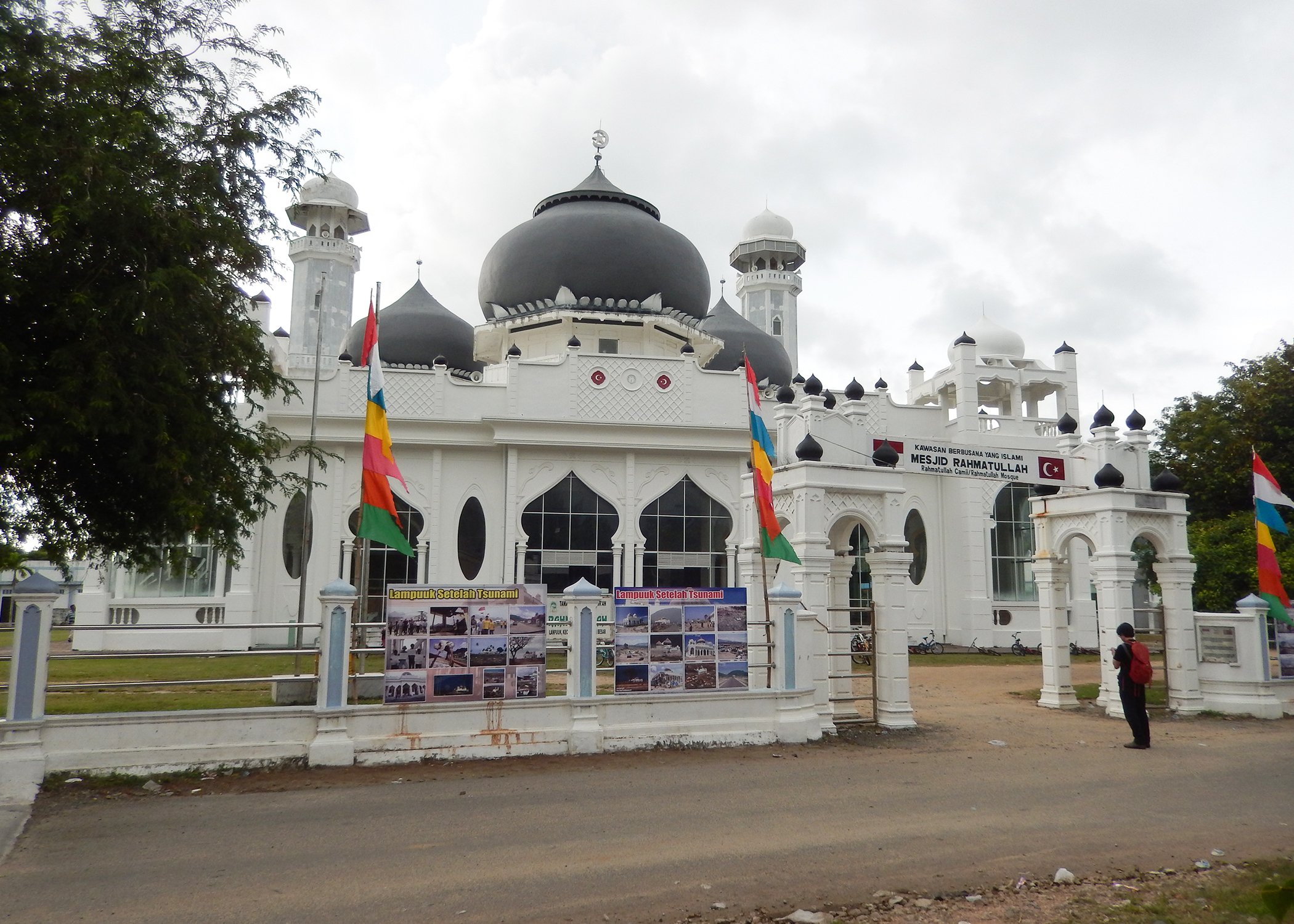 Image of a person standing at the entrance of a mosque