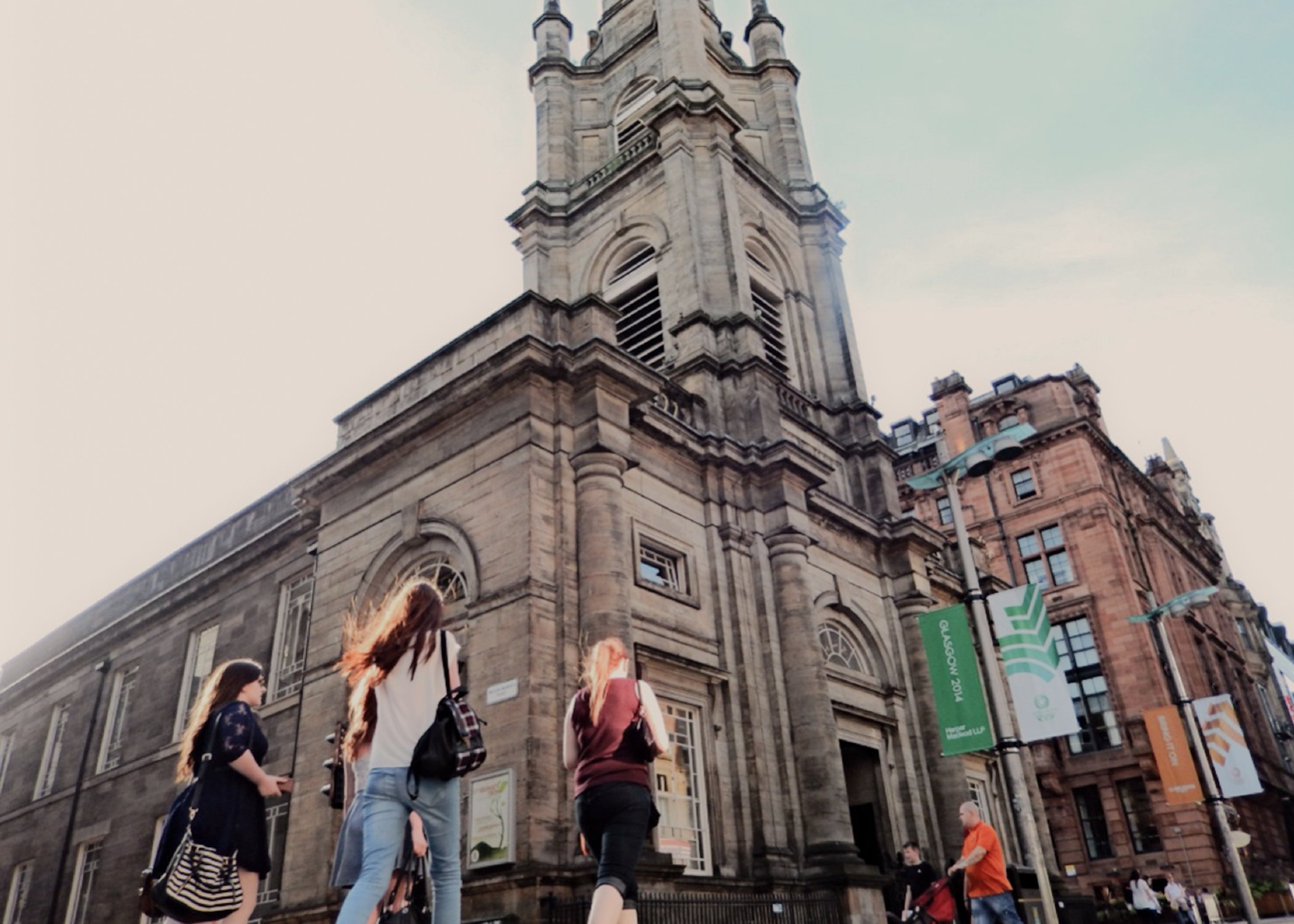 An image of people walking in front of a building